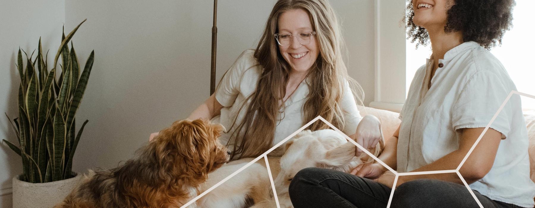people sitting on a couch with a dog